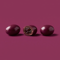 Nutbeads deep plum chocolate coated raisins, three pieces maximum with one cut open